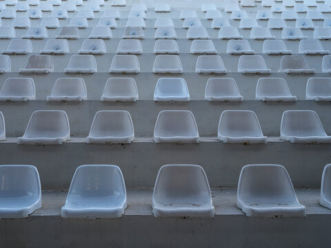 Empty white seats in a football stadium