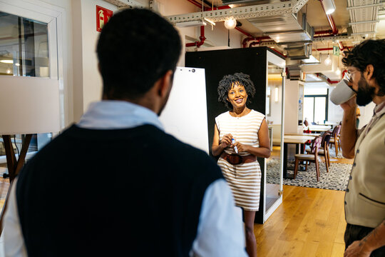 Group of diverse professionals interacting during a business meeting. African american woman leading a discussion with colleagues