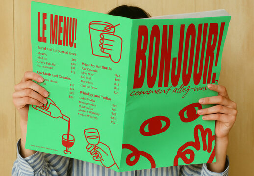 Female Hands Holding Retro Menu Mockup PSD With Bold Green And Red Cover
