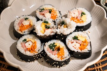 Rice Rolls with Sesame Served on Ceramic Plate, Close Up © Blessape