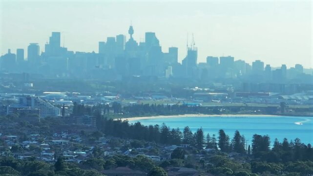 Long lens drone shot of Sydney city skyline with a plane taking off from Sydney airport, Australia