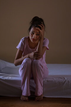 Young girl sitting alone in distress