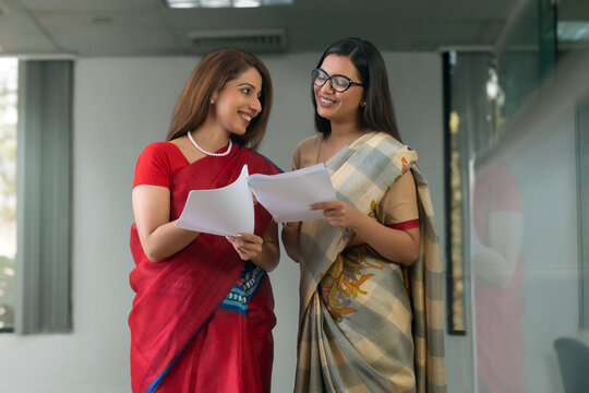 two employees analysing reports