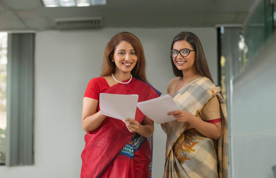 two employees analysing reports