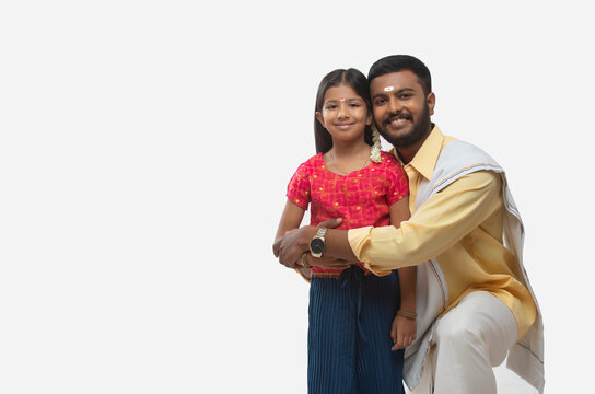 portrait of a south indian father and daughter smiling at the camera