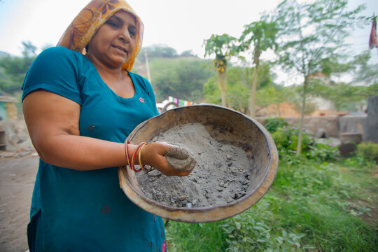woman using ash as a fertilizer