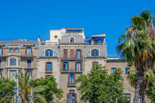 Traditional Residential Building Facade with Mansard Roof in Barcelona, Historic Architecture