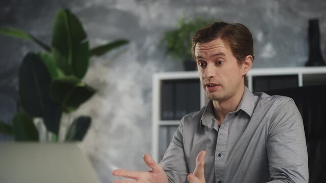 Young male entrepreneur having online video conference, business negotiations