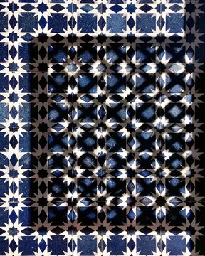Moorish geometric tile pattern with dramatic light and shadow