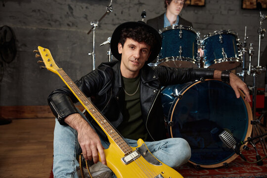 Relaxed musicians gear up for concert in authentic urban rehearsal space
