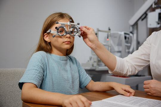Peaceful clinician patiently guides young girl during comprehensive eye screening process