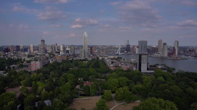 Panoramica skyline view of Rotterdam cityscape featuring the tall Zalmhaven tower and Erasmus Bridge, observed from the Euromast observation tower in the Netherlands.