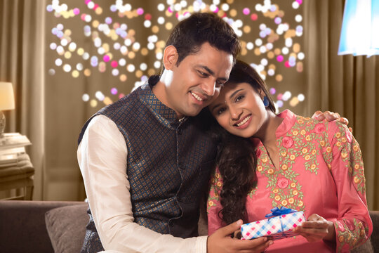Husband giving Diwali gift to his wife on diwali celebrations