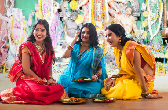 Three bengali Married women doing prepartion for Durga Puja