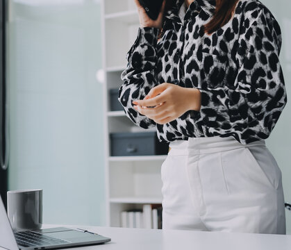 Confident asian business woman standing in modern office