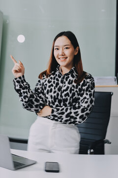 Confident asian business woman standing in modern office