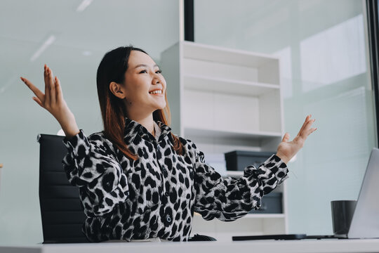 Confident asian business woman standing in modern office