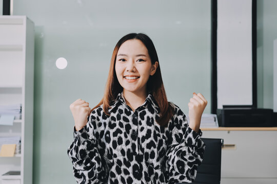 Confident asian business woman standing in modern office