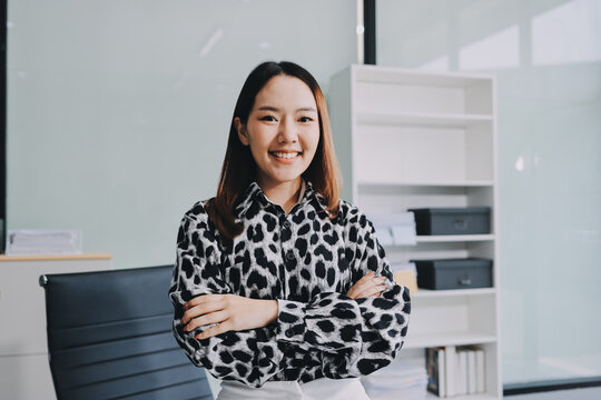 Confident asian business woman standing in modern office
