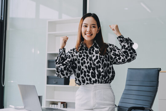 Confident asian business woman standing in modern office