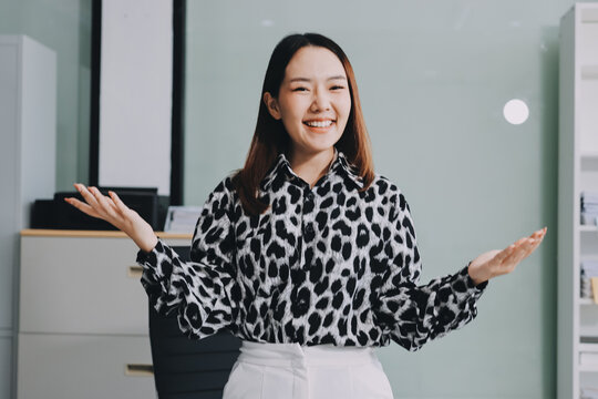 Confident asian business woman standing in modern office