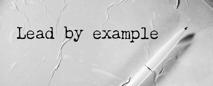 Lead By Example is shown using the text
