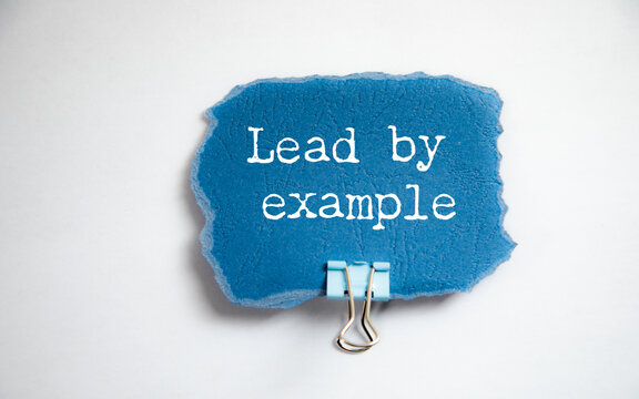 Lead By Example is shown using the text