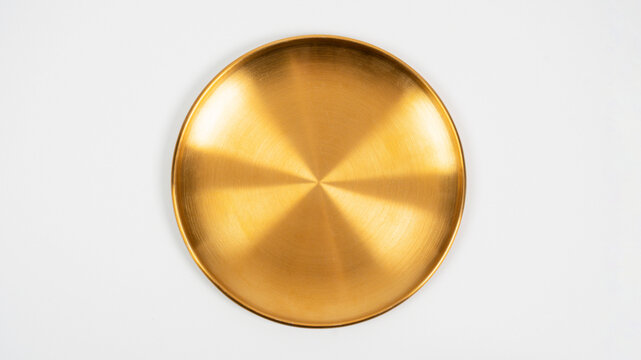 A gold-colored porcelain plate, a plate of food, against a white background.