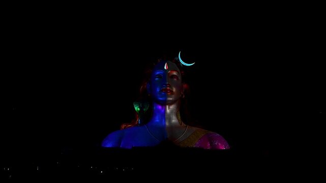 View of Adiyogi shiva statue illuminated by spectacular 3D laser light show at night