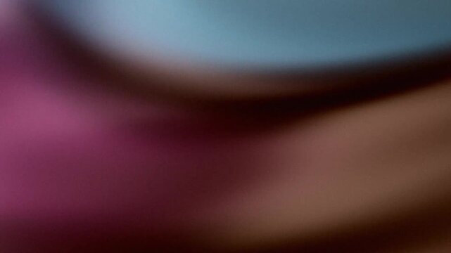Abstract grainy gradient background with purple, blue, and brown tones