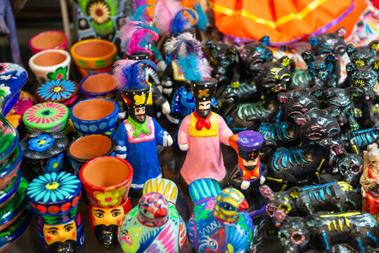 Traditional Chinelos Figures Surrounded by Colorful Mexican Folk Art at Artisan Market