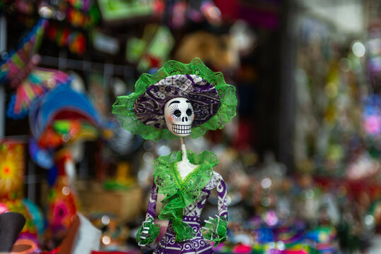 Hand Painted Mexican Catrina Doll Wearing Green Dress At Artisan Market