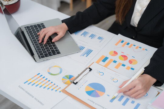 Business financing accounting banking concept. Business woman hand doing finances and calculate on desk about cost at home office. Woman working on desk with using calculator, finance accounting.	