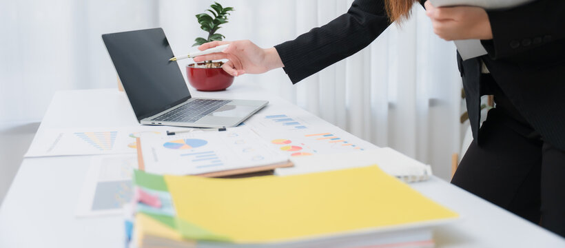 Business financing accounting banking concept. Business woman hand doing finances and calculate on desk about cost at home office. Woman working on desk with using calculator, finance accounting.	