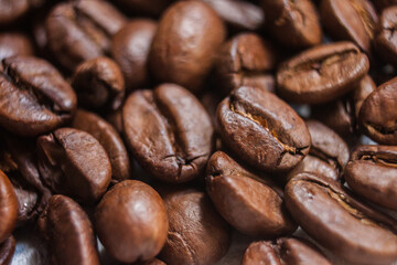 Fototapeta premium Macro Roasted Coffee beans artistic shot photography, brown bean, Arabica, Robusta, Liberica, Excelsa, Kopi Luwak and Black Ivory, freshness aromatic caffeine, selective focus, Cairo Egypt