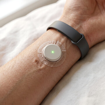 Quantified self concept, arm with plain health monitoring devices, no branding, morning light texture detail, 1:1 format