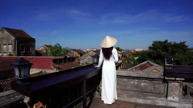 Tourist enjoying viewpoint on rooftop at Hoi an ancient town, Vietnam.