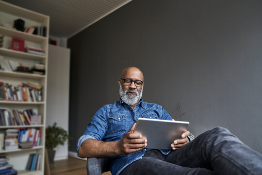 Mature man using digital tablet