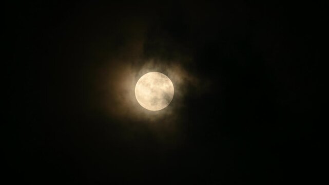The July Full Moon is known as the ''Buck Moon'' in Native American tradition, coinciding with Guru Purnima. See black storm clouds, tree branches, electric wire, and construction, lunar corona
