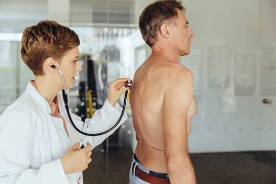 Female doctor examining patient with a stethoscope