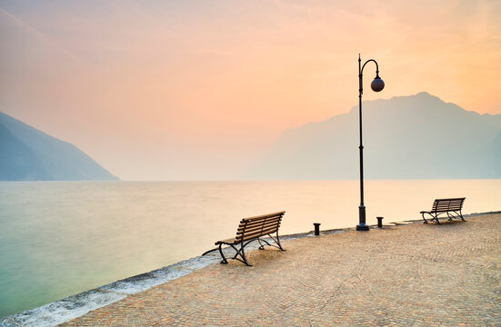 Italy, Torbole, empty benches at Lake Garda in winter