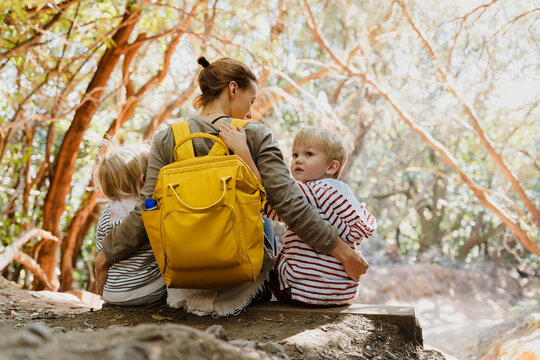 Mother hugs her children during a hike in Anaga Rural Park