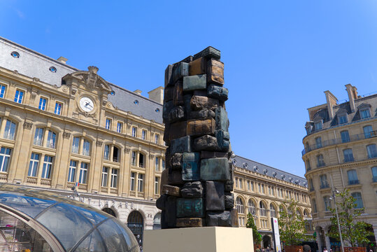 Bronze sculpture by Arman named consigne &agrave; vie erected 1985 at Cour de Rome town square on a sunny summer day. Photo taken July 13th, 2026, Paris, France.