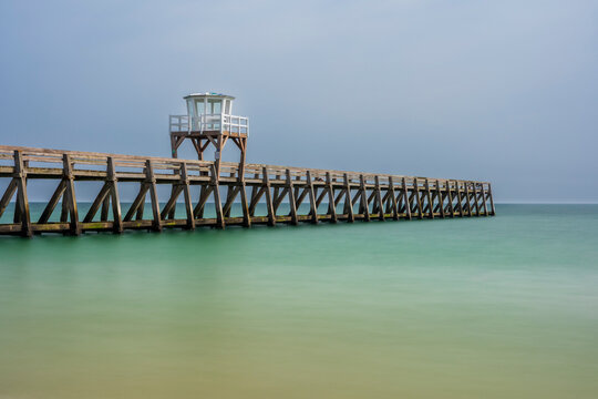 Tranquil long exposure of Luc sur Mer jetty in Normandy