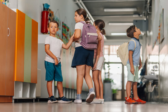 Elementary students walking school hallway during break time