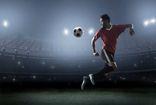 Football player showing skills with ball in stadium