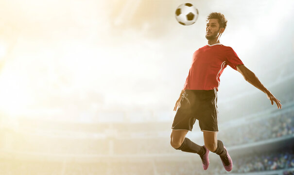 Football player landing ball on his chest in stadium