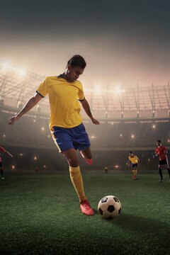 Football player kicking ball in stadium