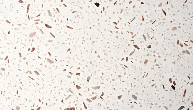 A close-up view of a white terrazzo stone surface with multi-colored marble chips embedded in the concrete texture.