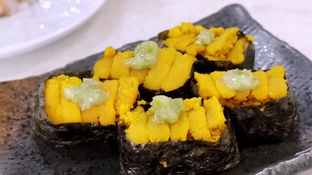 Close-up of fresh uni sushi featuring premium sea urchin served on seasoned Japanese rice, highlighting rich texture and authentic gourmet presentation.